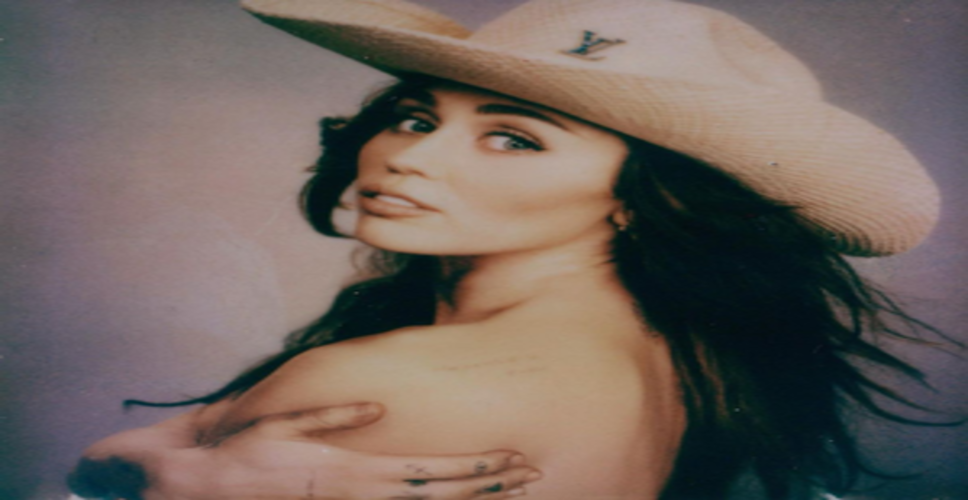 Miley Cyrus goes topless in new social media pictures as family deals with tension